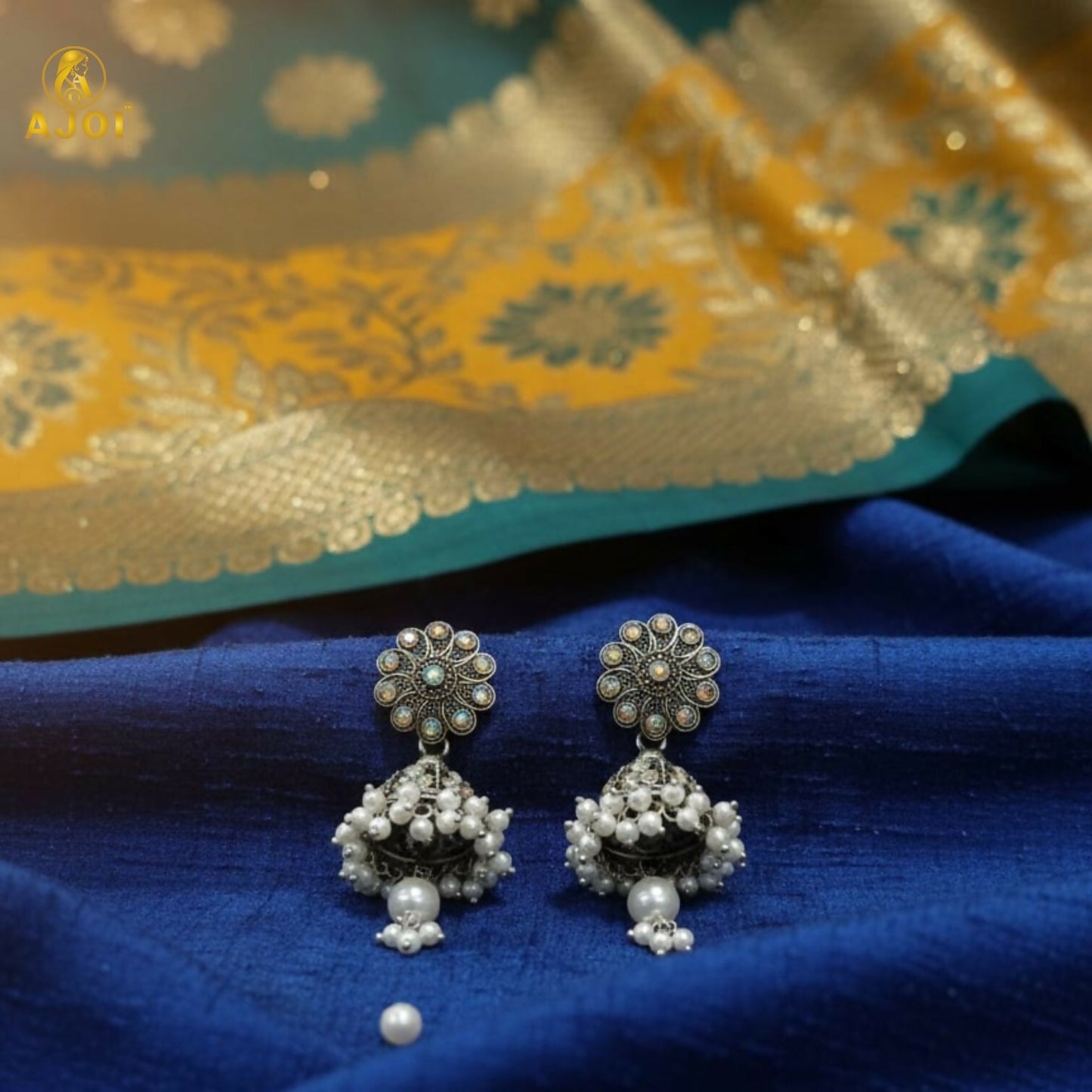 Side angle of oxidised silver jhumka earrings showcasing intricate design