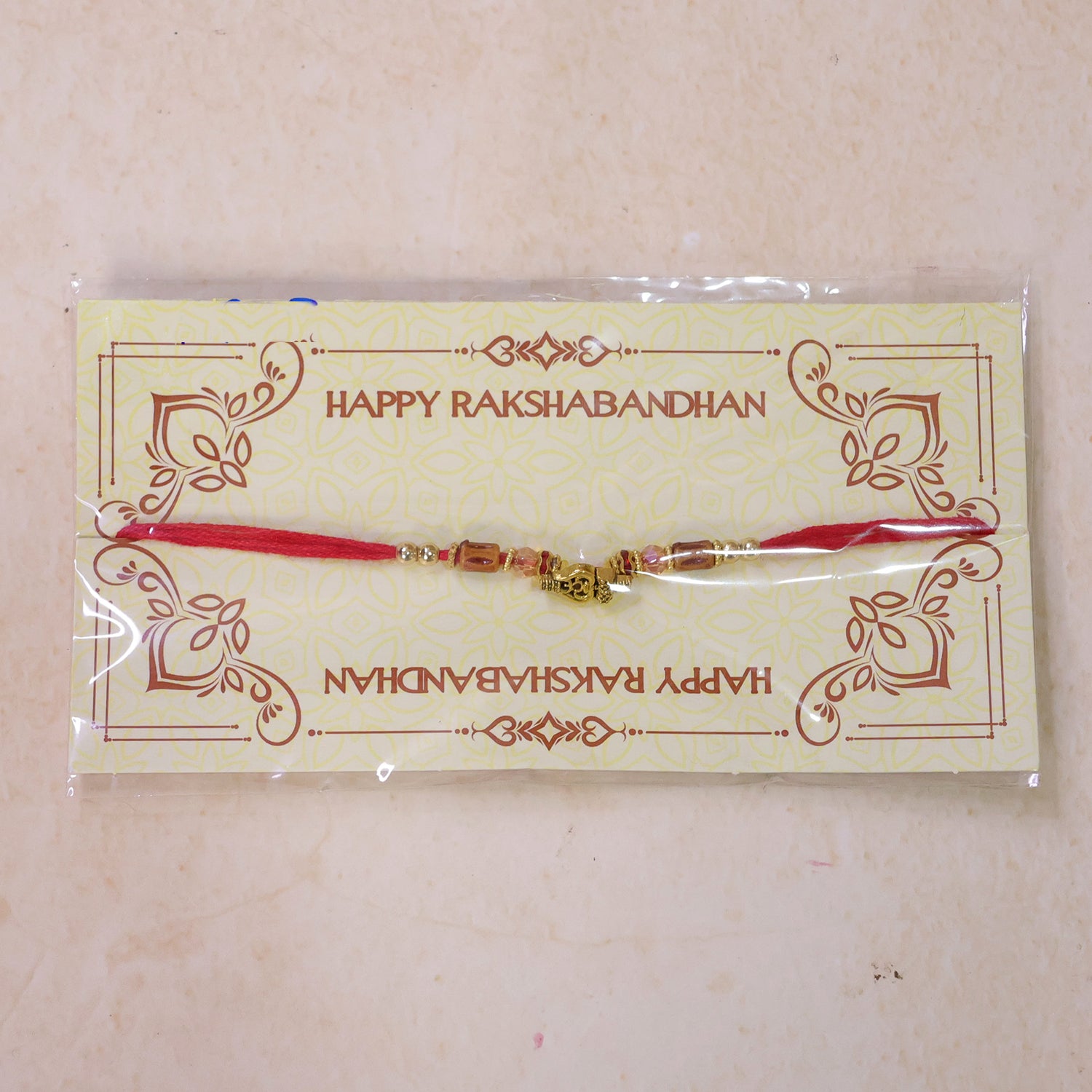 Red Thread Rakhi with Amber Beads and Antique Gold Lantern Charm