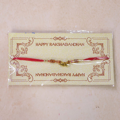 Red Thread Rakhi with Amber Beads and Antique Gold Lantern Charm