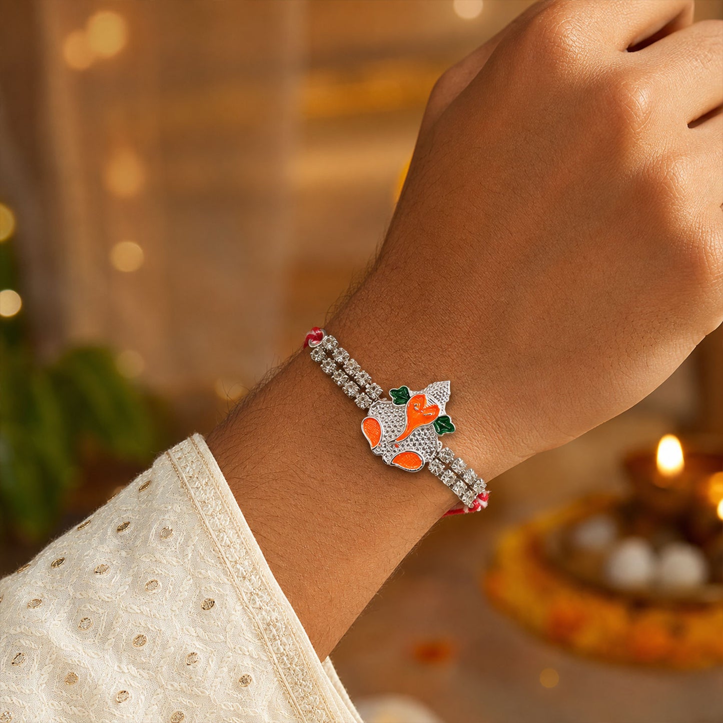 Silver-Toned Bal Ganesha Rakhi with Orange-Green Enamel, Double Crystal Chain & Red-White Thread