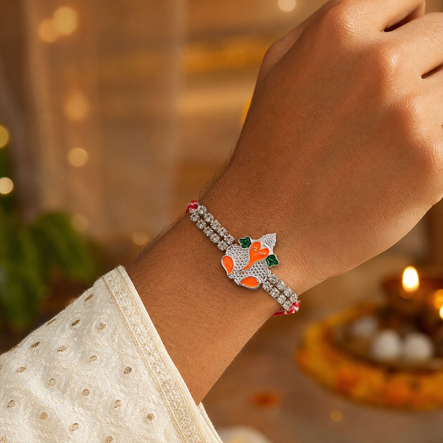 Silver-Toned Bal Ganesha Rakhi with Orange-Green Enamel, Double Crystal Chain & Red-White Thread