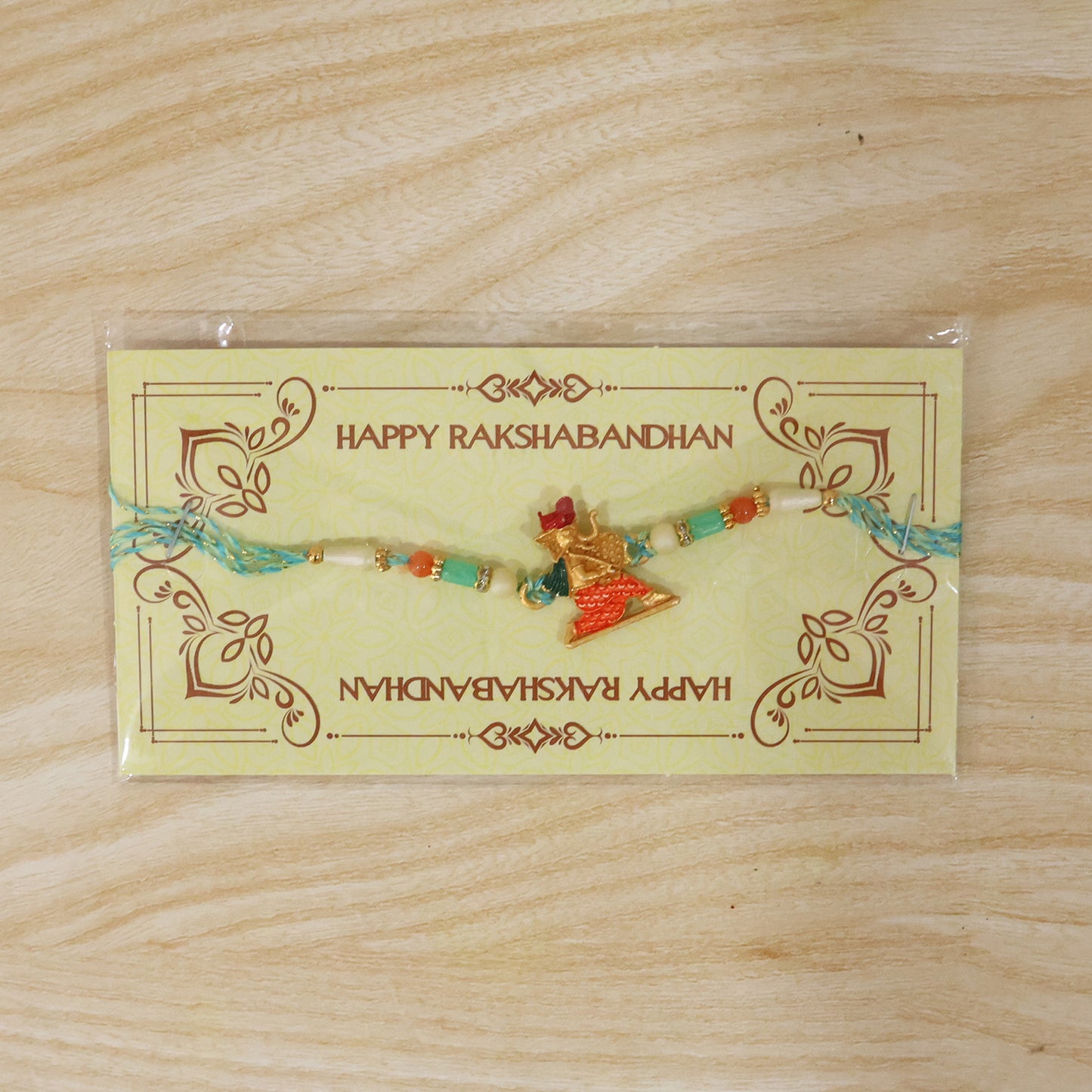 Colorful Ganesh Rakhi for Boys with Beads and Red-Blue Thread