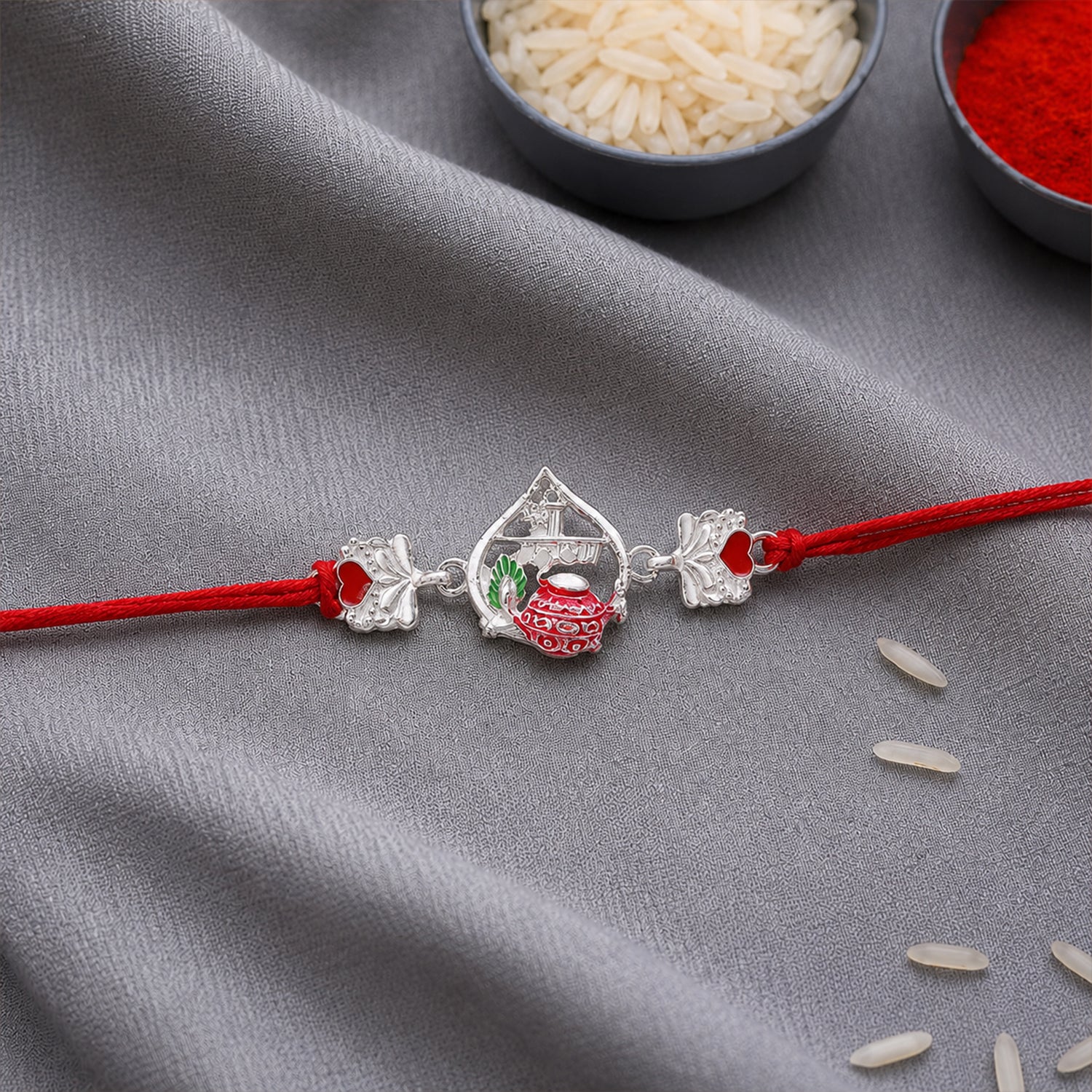 Silver Crown Rakhi with Pink Stone Center and Red Mauli Thread