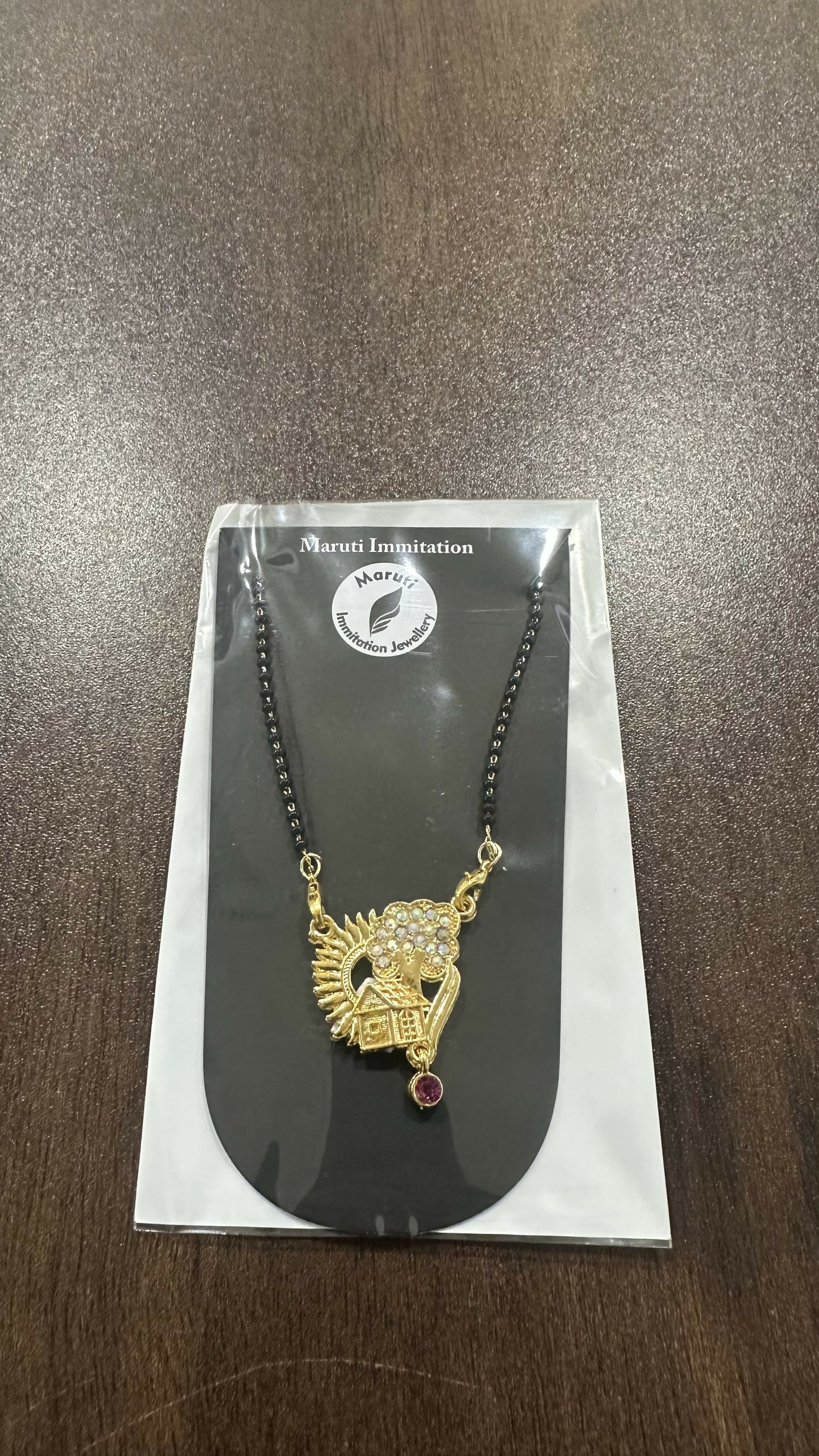 The Sun & Home Charm That's a beautiful piece of artificial jewelrywith a very unique and meaningful design.