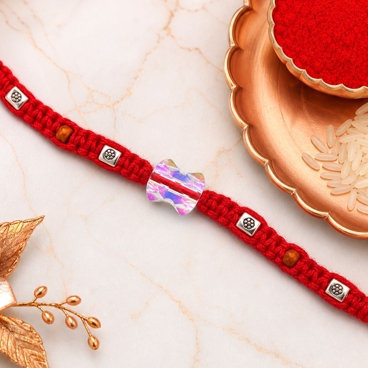 Red Braided Rakhi with an Iridescent Bow-Tie Shaped Crystal Bead