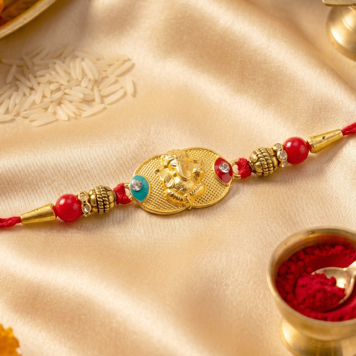 Golden Ganesh Rakhi for Boys with Red and Green Beads