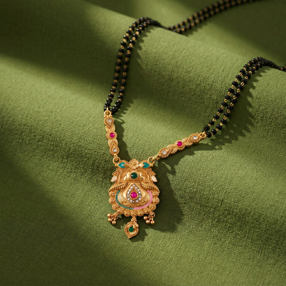 Elegant pendant with green teardrop stone and ruby accents, perfect for ceremonies