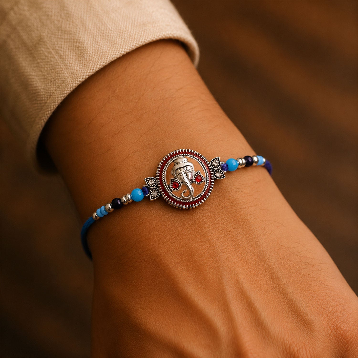 Round Ganesha Medallion Rakhi with Blue Thread, Roli Chawal Coin and Peacock Card Packing