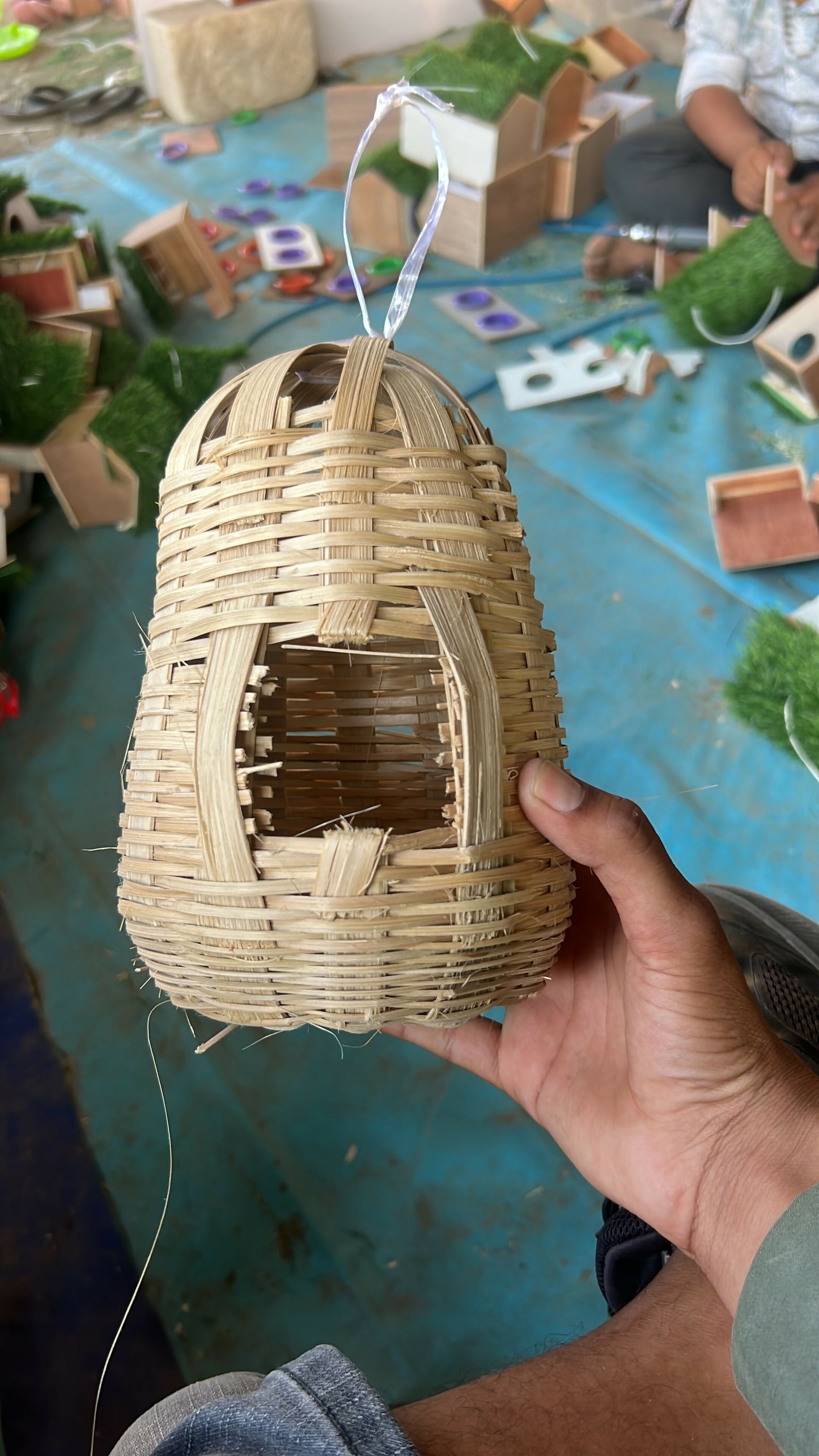 Bamboo bird nest hanging on a tree branch in garden
