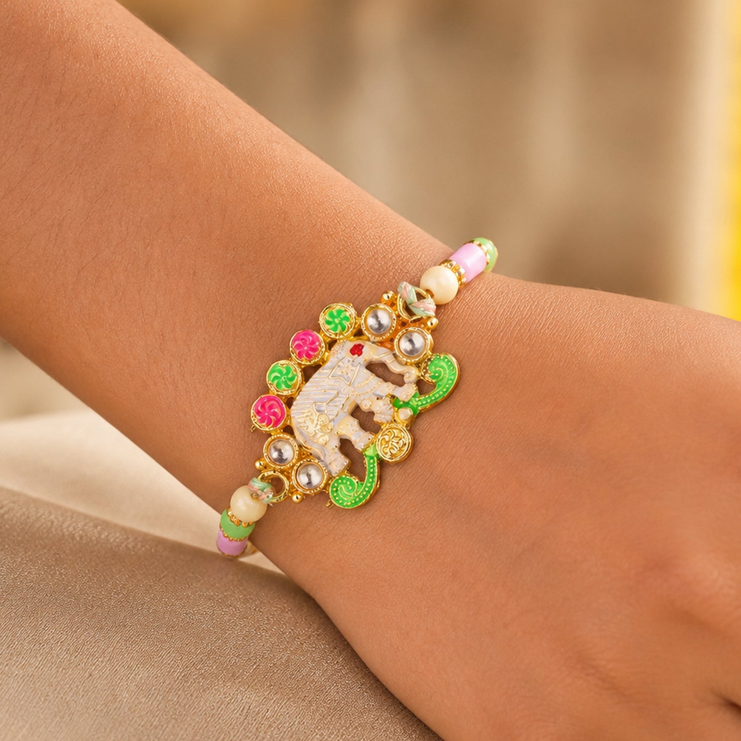 Festive Rakhi showcasing Elephant Charm, gold trims and display look for Gift Use