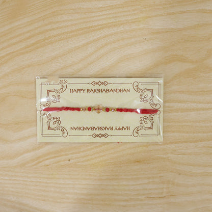 Red Thread Rakhi with a Row of Sparkling Crystal Bead Pendant Accents