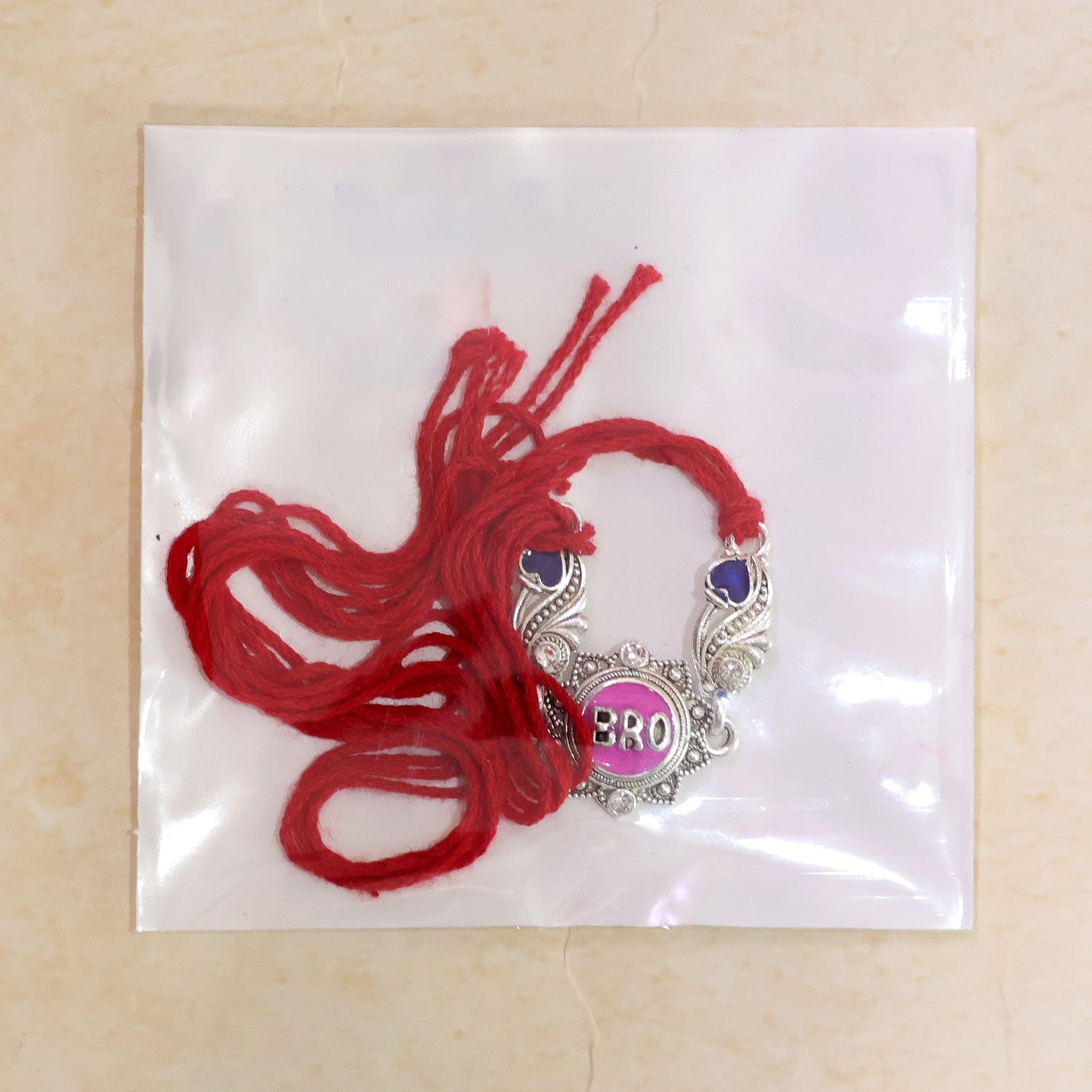 Silver-Toned BRO Rakhi with Pink Enamel, Blue Heart Accents, Crystals & Red Thread