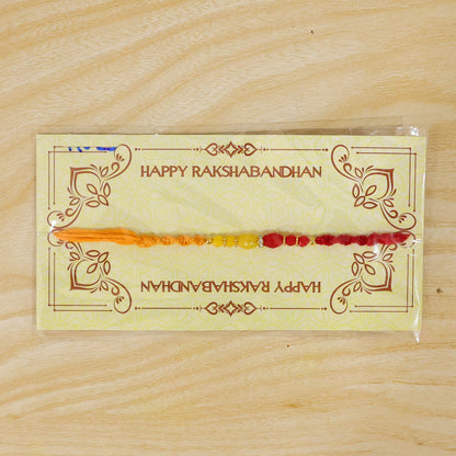 Red Thread Rakhi with Yellow and Orange Bead Pendant Accents