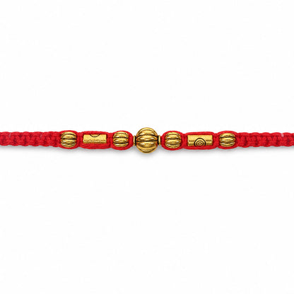 Red Braided Rakhi with a Row of Smooth Golden Bead Accents