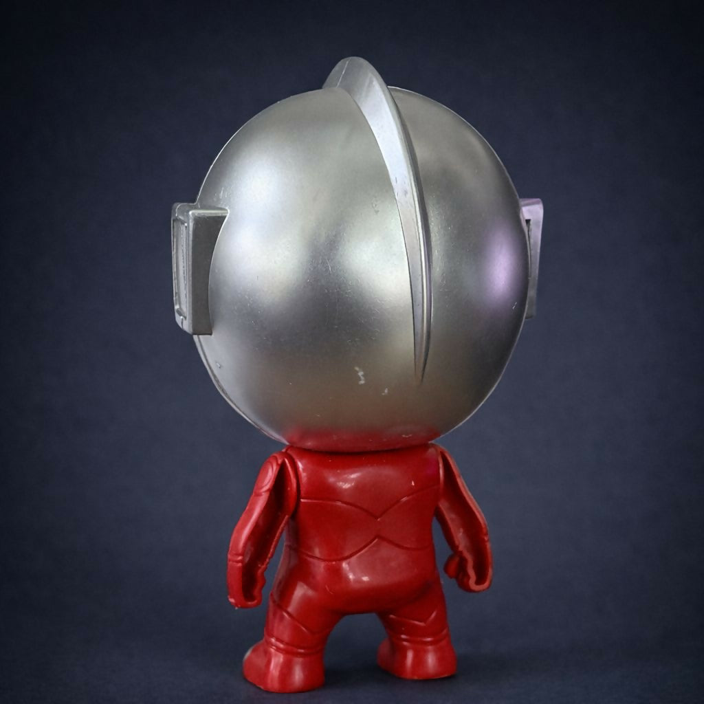 Child holding opened superhero capsule toy with figure