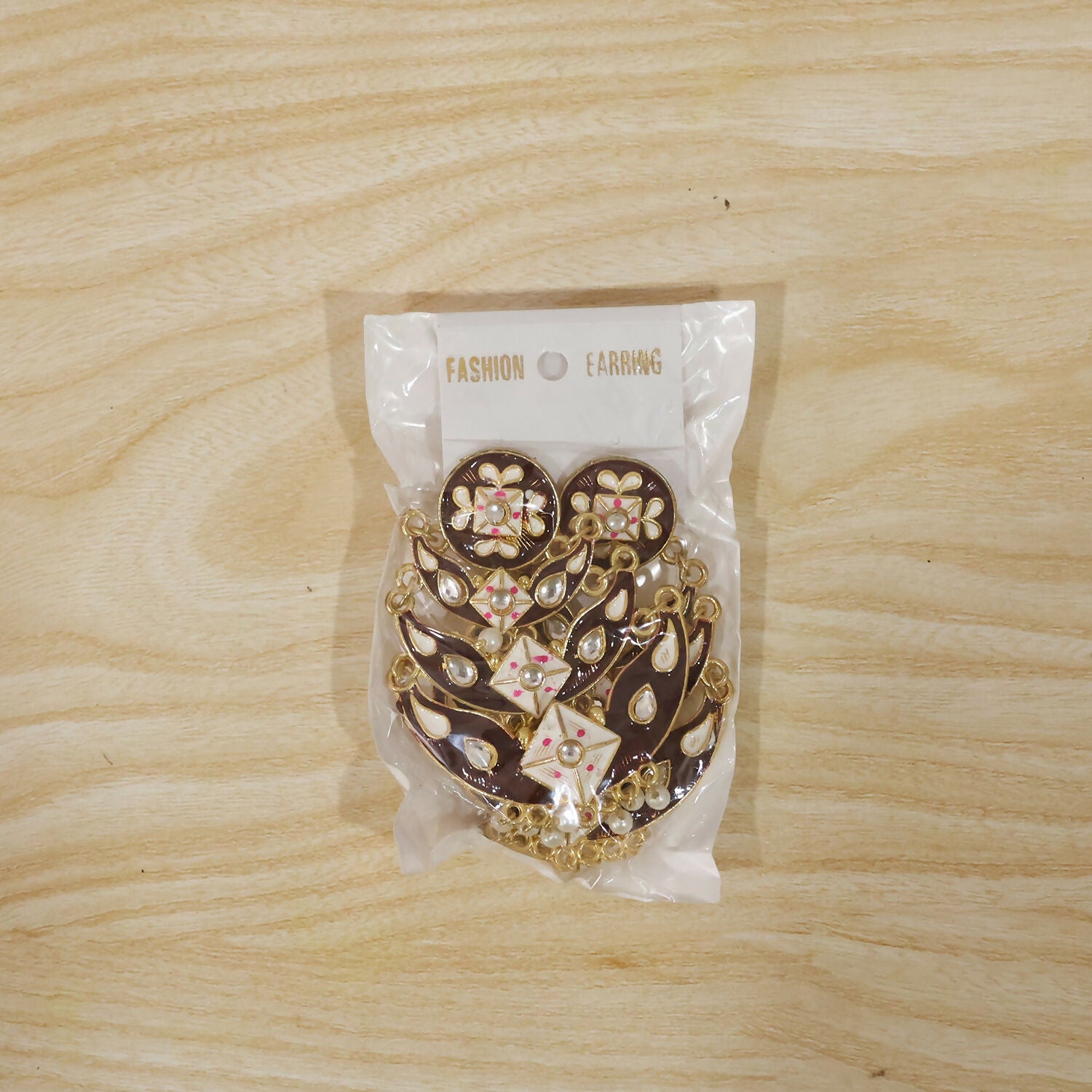 Earring worn on ear displaying elegant black meenakari design