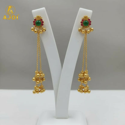 Close-up of emerald center stone and ruby accents on gold-plated Kashmiri earrings