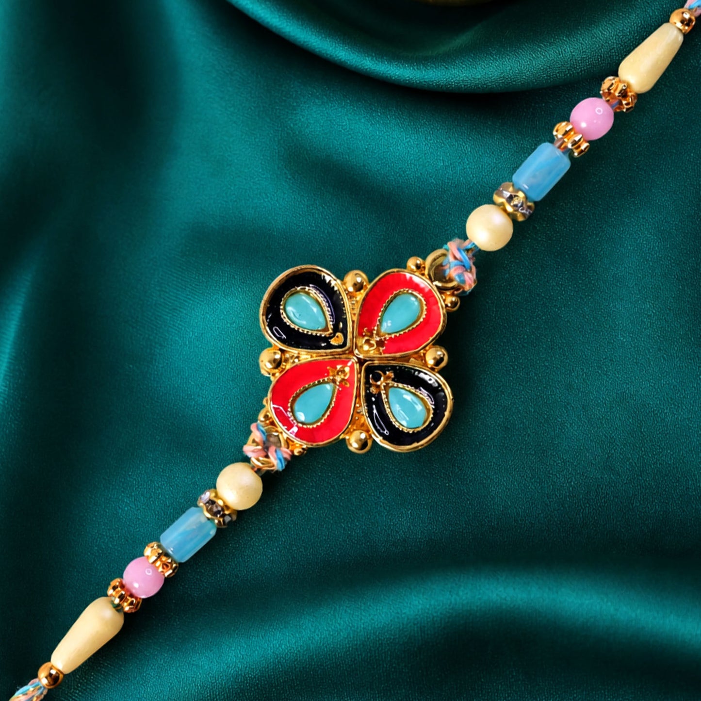 Four-Petal Floral Rakhi with Cream Thread, Multicolor Enamel and Floral Motif Design