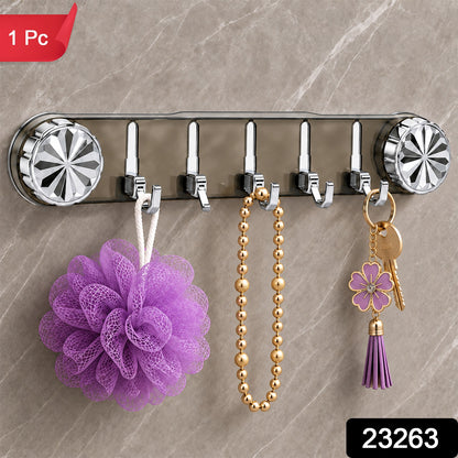 A gray transparent wall rack with five silver folding hooks holds a purple loofah, a gold beaded necklace, and a – view 2