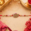 Radha Krishna Script Pendant Rakhi with Pink Kundan Beads