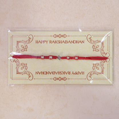 Red Thread Rakhi with Silver Square Beads and Diamond-Shaped Charm