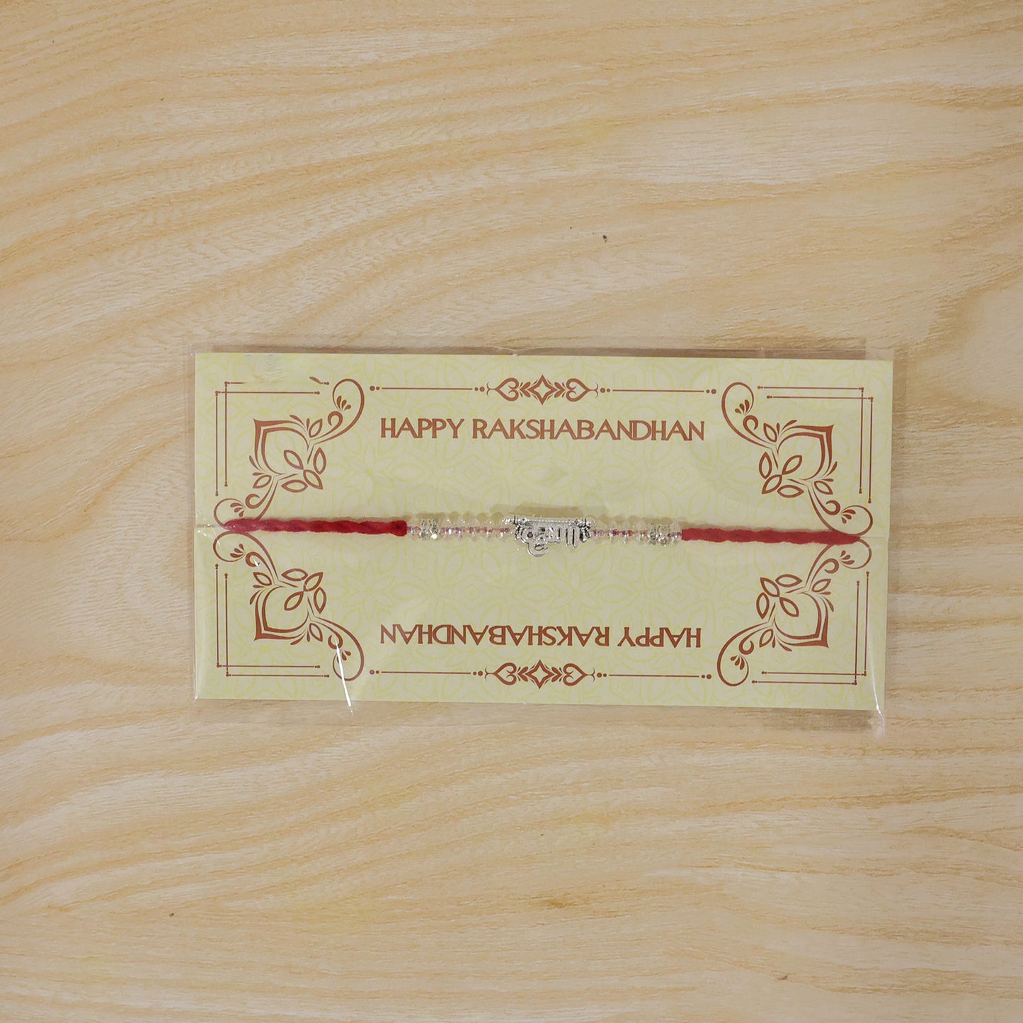 Silver Bhaiya Name Rakhi with Crystal Beads, Red Thread and Sparkling Detail