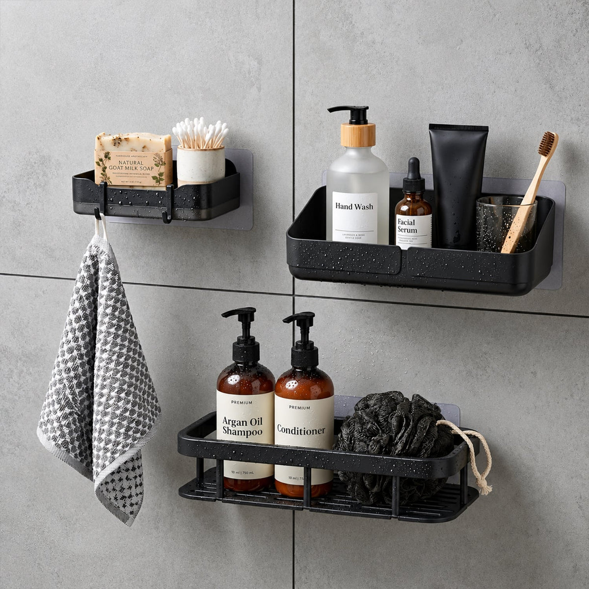 Three black plastic shower caddies with different personal care items and a patterned towel hanging.