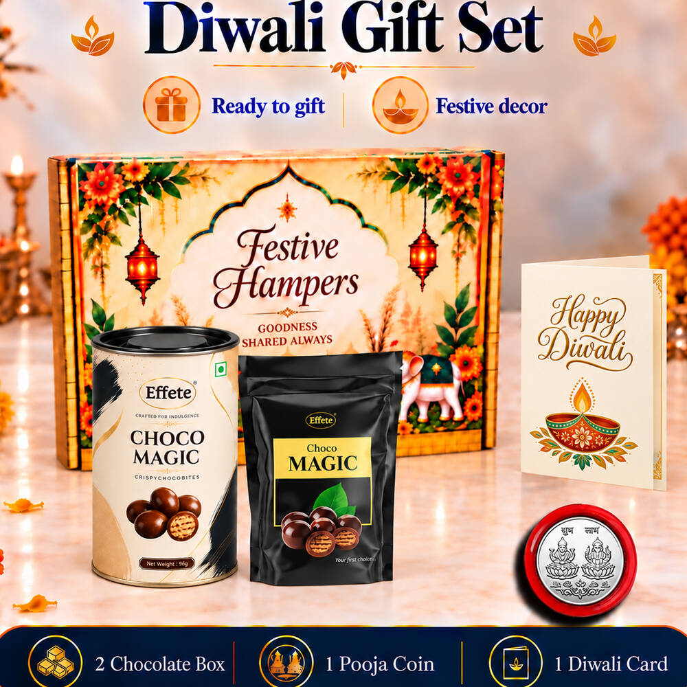 A festive hamper box, two chocolate containers, a silver coin, and a Happy Diwali card on a reflective surface.
