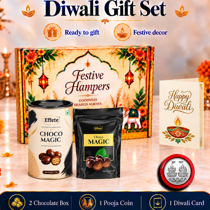 A festive hamper box, two chocolate containers, a silver coin, and a Happy Diwali card on a reflective surface.