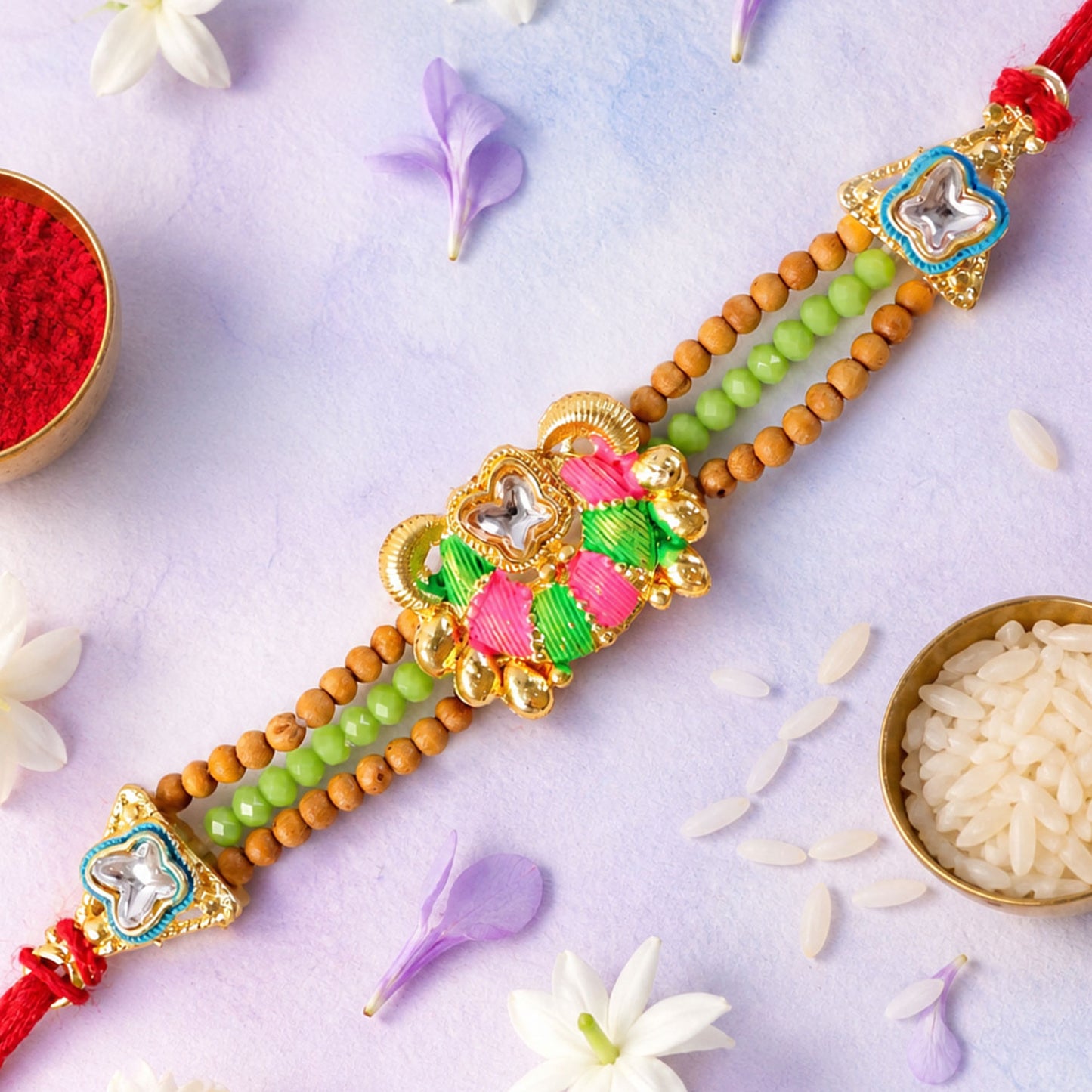 Green Beaded Floral Rakhi with Pink Center and Colorful Festive Gifting Elegance