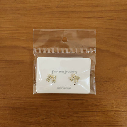 Elegant crystal bow stud earrings on white background