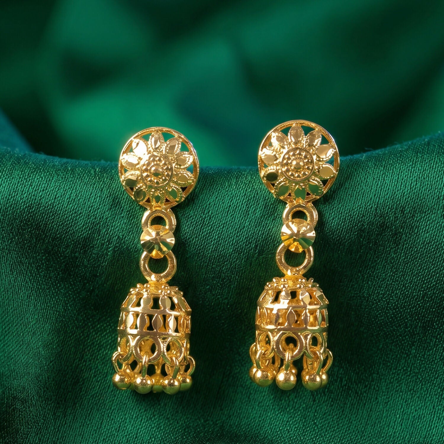 Side view of gold-plated jhumka earrings showing chain detail