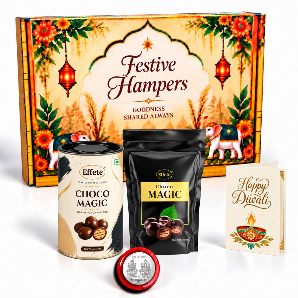 A festive hamper box with two chocolate containers, a silver coin, and a Happy Diwali card.