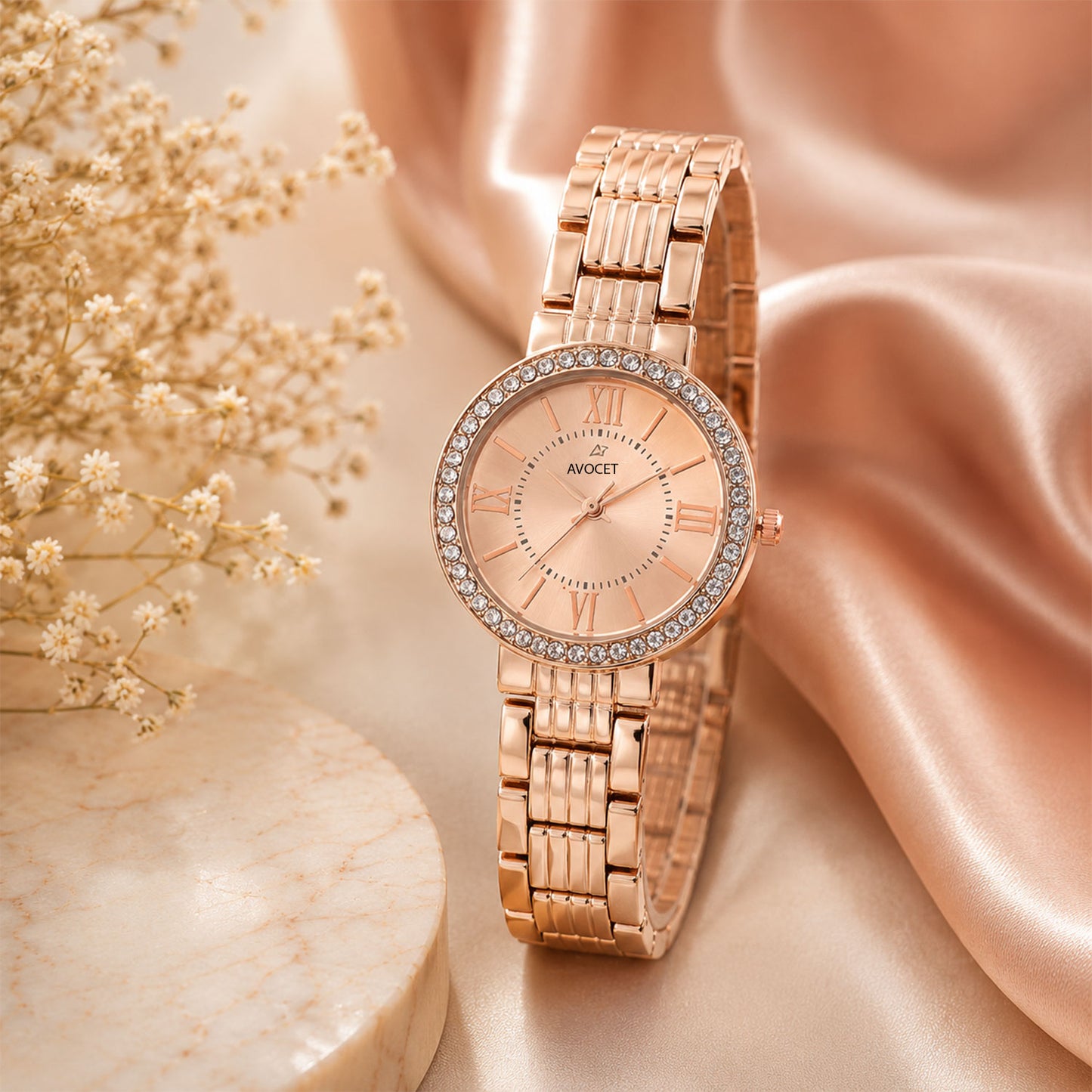 Close-up of the women's rose gold watch showing its sparkling crystal bezel and metal strap.