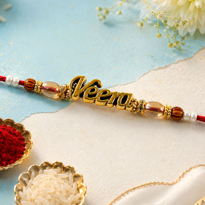 Veera Name Golden Rakhi with White Brown Beads, Red Thread and Premium Finish