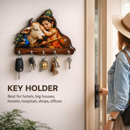 Close-up of Baby Krishna and cow artwork on wooden key holder