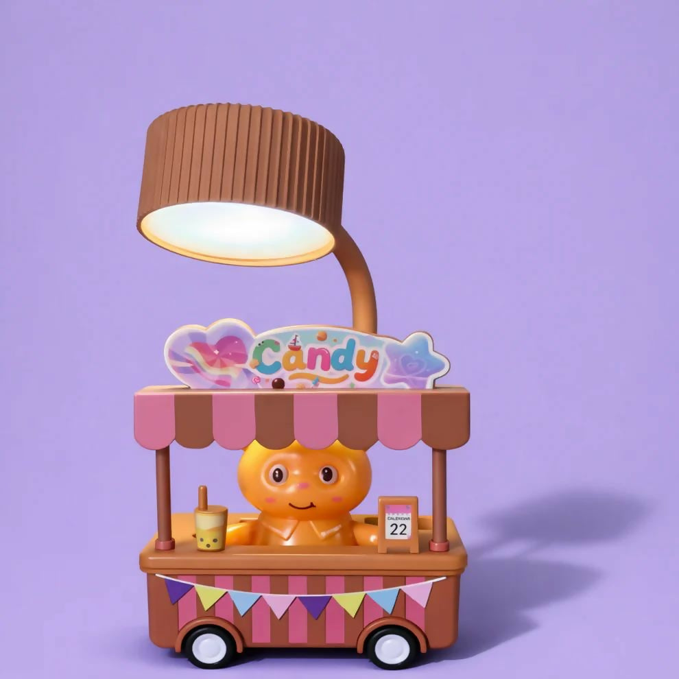 A brown and pink candy cart desk lamp with a glowing light, on a solid light purple background.
