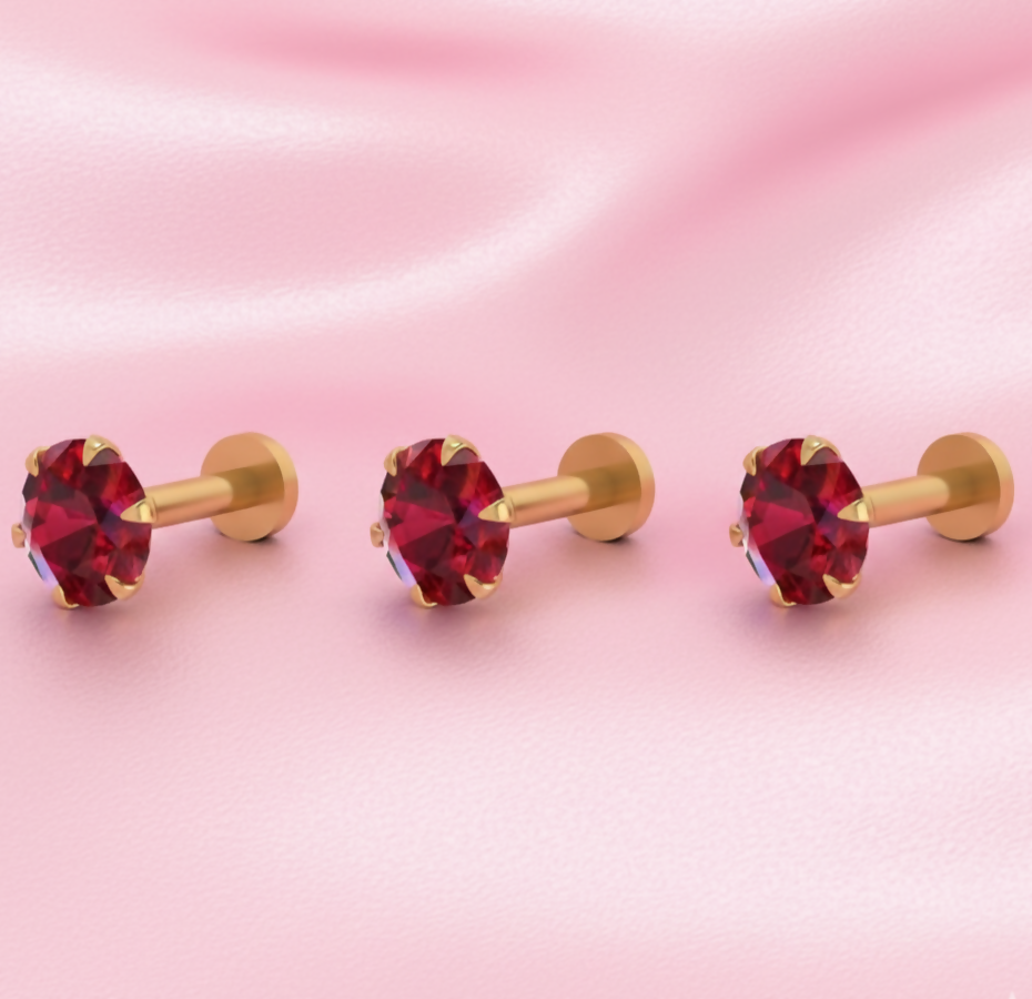 Close-up of lab-grown ruby set in gold plated nose stud