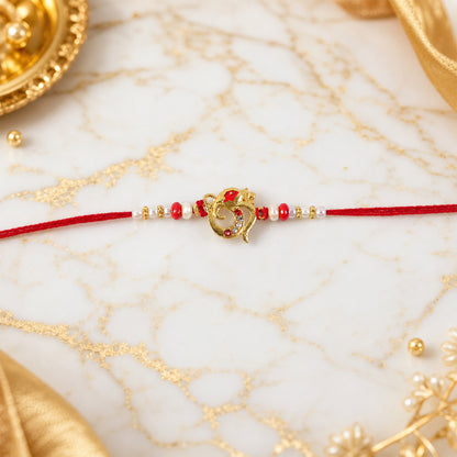 Golden Om Rakhi with Red Beads and Pearl Dotted Thread