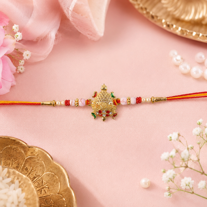 Gold Turtle Rakhi with Pink Pearls and Red Thread