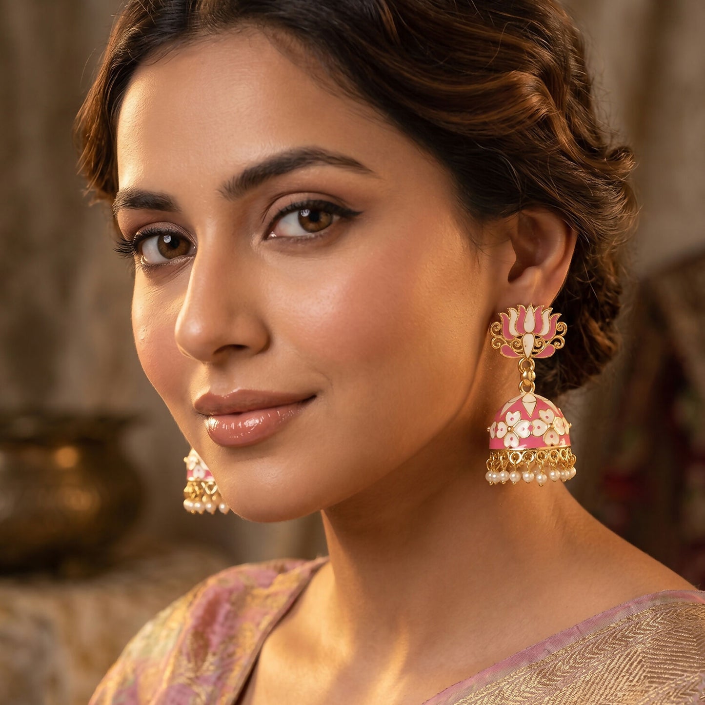 Close-up of pink lotus jhumka earrings with pearl detailing