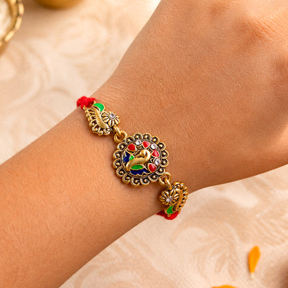 Antique Gold-Toned Peacock Rakhi with Multicolor Enamel, Crystal Accents & Red Thread