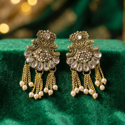Matching gold and pearl earrings paired with necklace