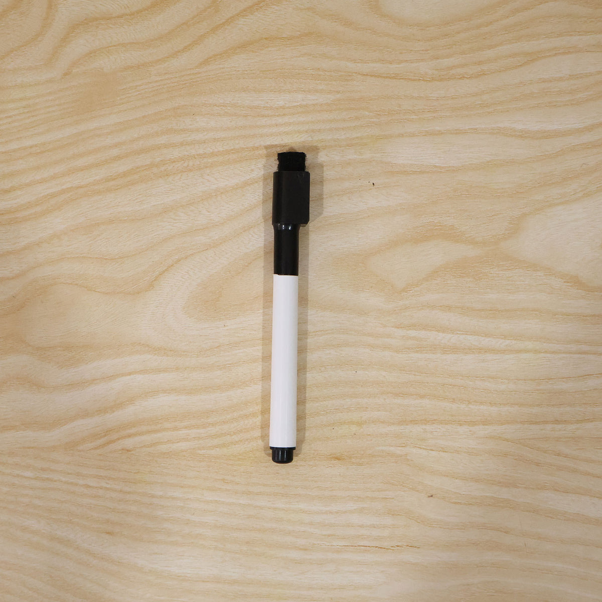 Black dry erase marker in use on a whiteboard