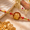 Traditional Rakhi with Red Pearls & Elegant Center – Festive Style