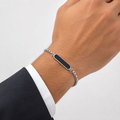 Man wearing a personalized silver bracelet on his wrist