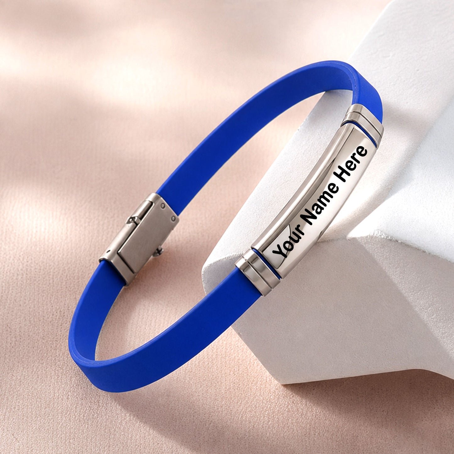 Close-up of the silicone and metal bracelet, highlighting the smooth texture and metallic accent.