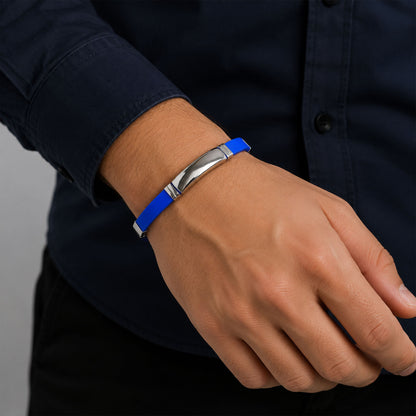 Full view of the silicone and metal bracelet laid flat, demonstrating its sleek unisex design.