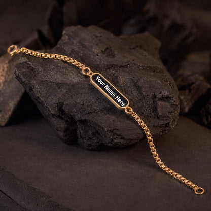 Close up of the black enamel nameplate on the personalized dual-tone chain bracelet.