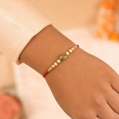 Divine Circular Medallion Bhai Bhabhi Rakhi with Oval Charm and Bead Accents for Gift